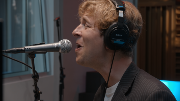 Tight shot of Tom Odell singing a song from A Wonderful Life